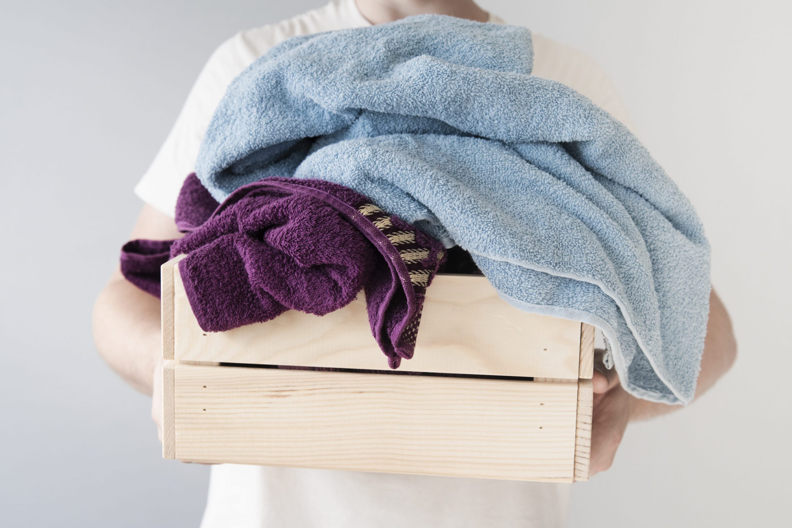 front-view-person-holding-laundry-box-min