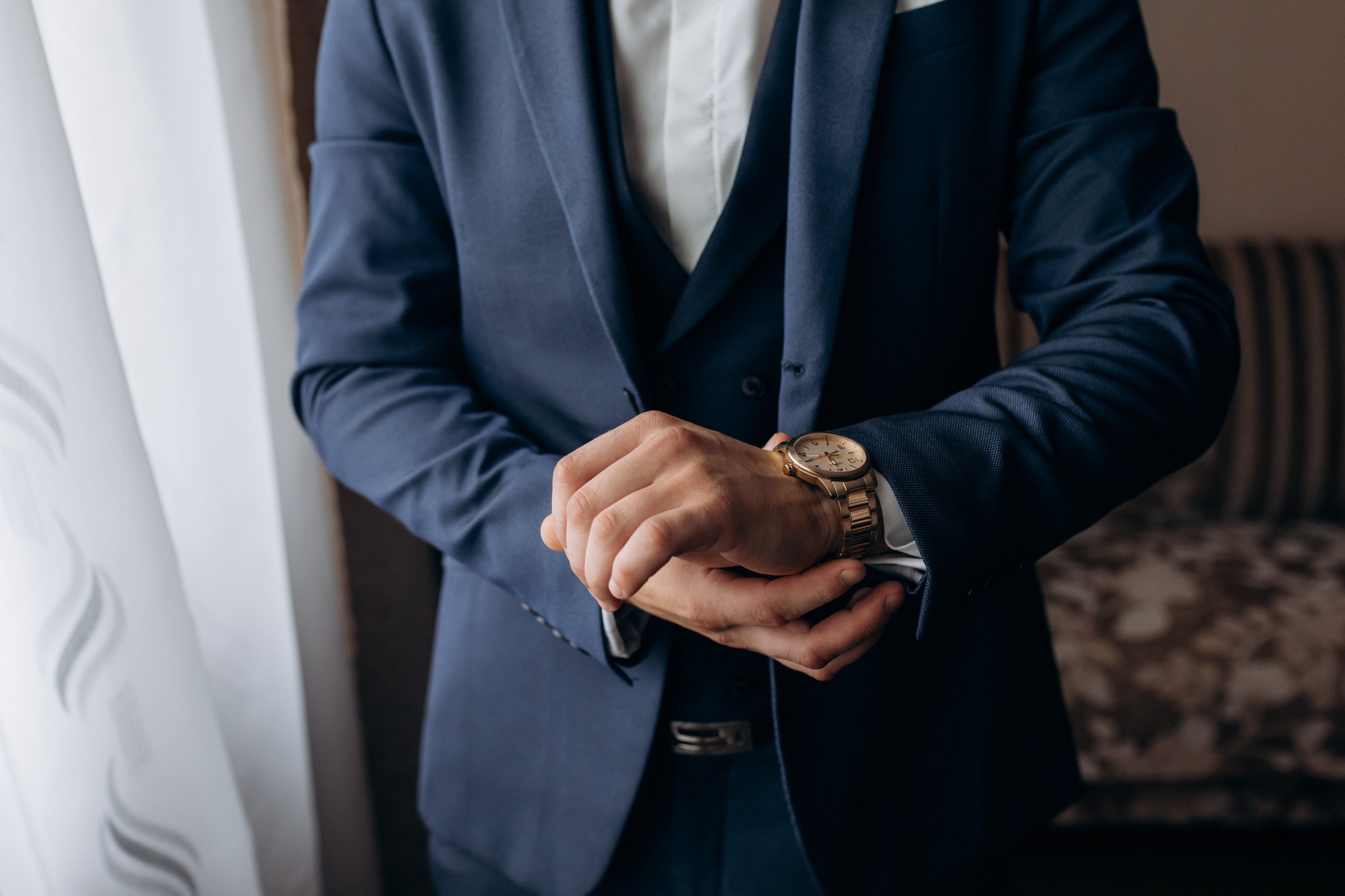 man-dressed-stylish-blue-suit-who-is-putting-elegant-watch-min